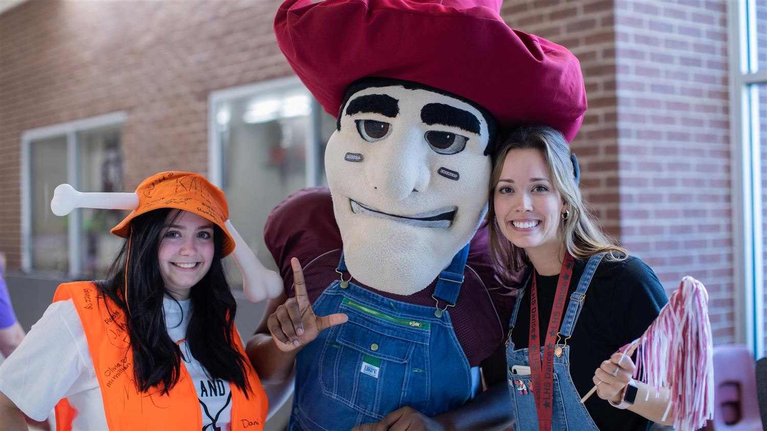  Lewisville High School's Big John poses with spirited members of the LHS community